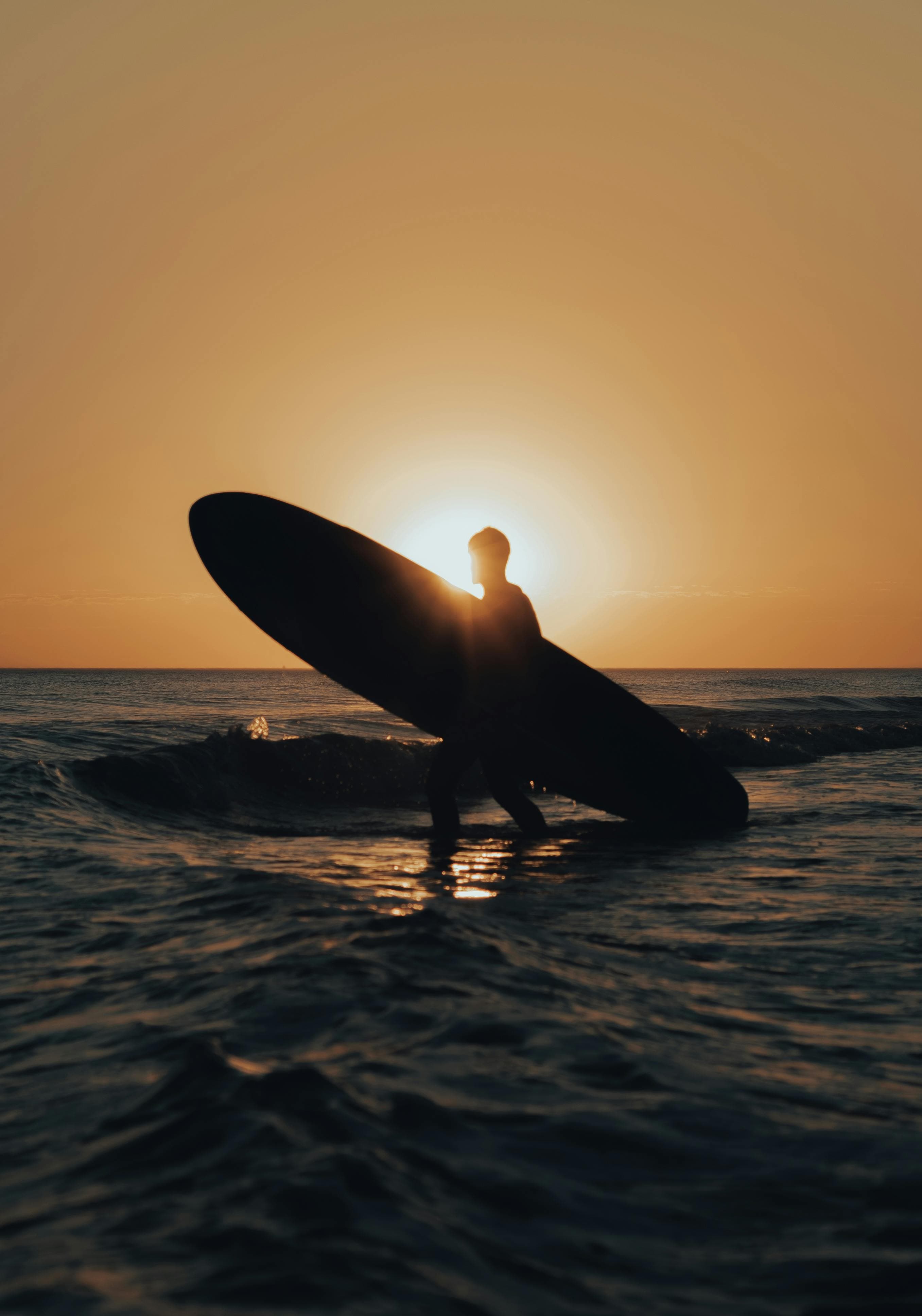 Surfer at golden hour on the Salvadoran coast